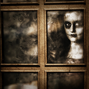 Scary murderer standing by the window with handgun