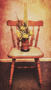 Decorated flower bunch on old wooden chair